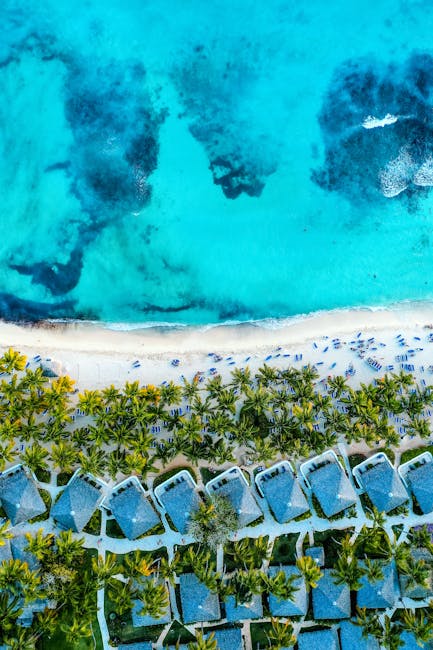 Stunning aerial shot of Bayahíbe's vibrant coastline, showcasing turquoise waters and beachfront villas.