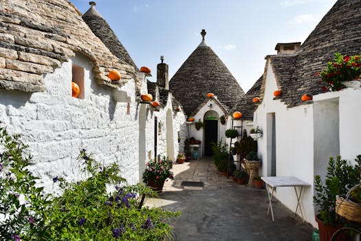 Discover the unique trulli houses in Alberobello, Italy, featuring conical roofs and vibrant decorations.